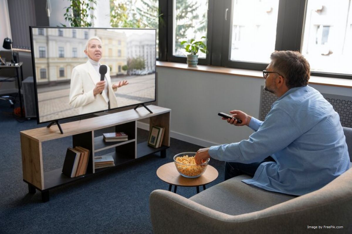 Um homem apontando controle remoto para a TV ilustra nosso artigo sobre: As 10 melhores marcas de TV Box do mercado brasileiro.